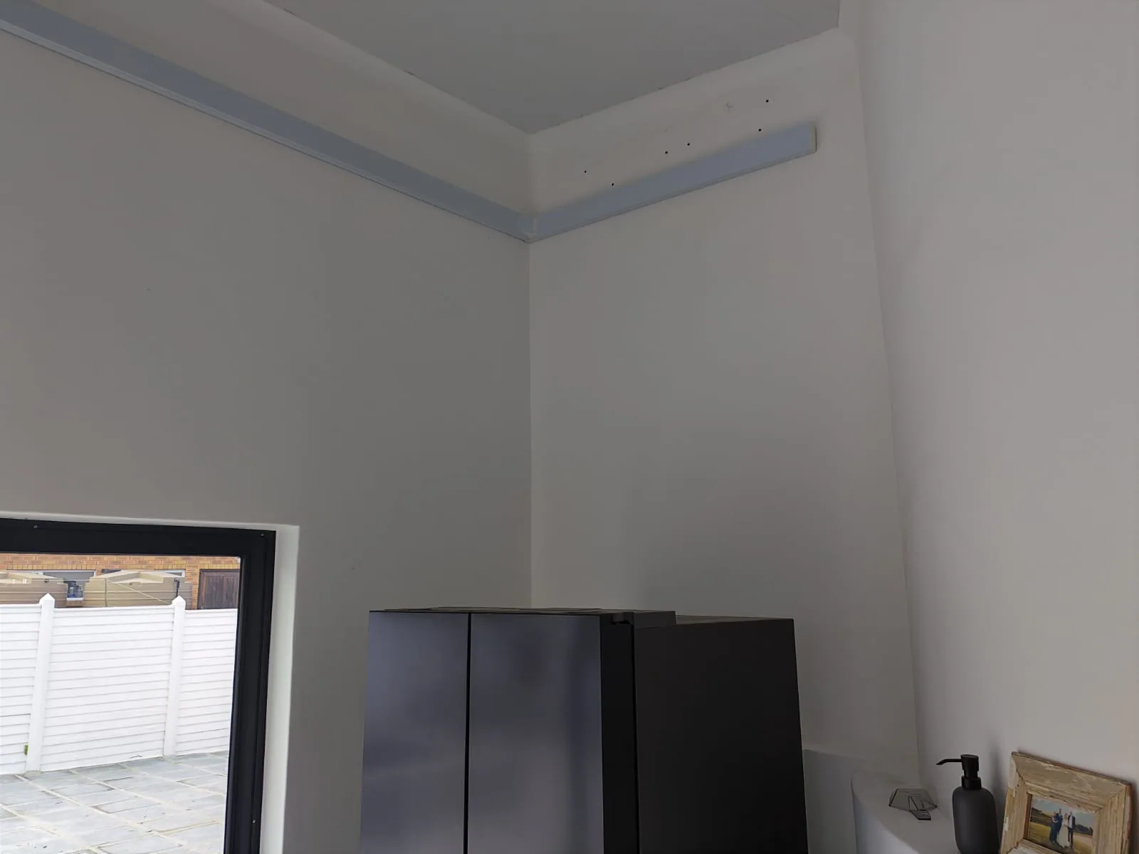 Indoor air-conditioning installation with enclosed trunking beside the unit.