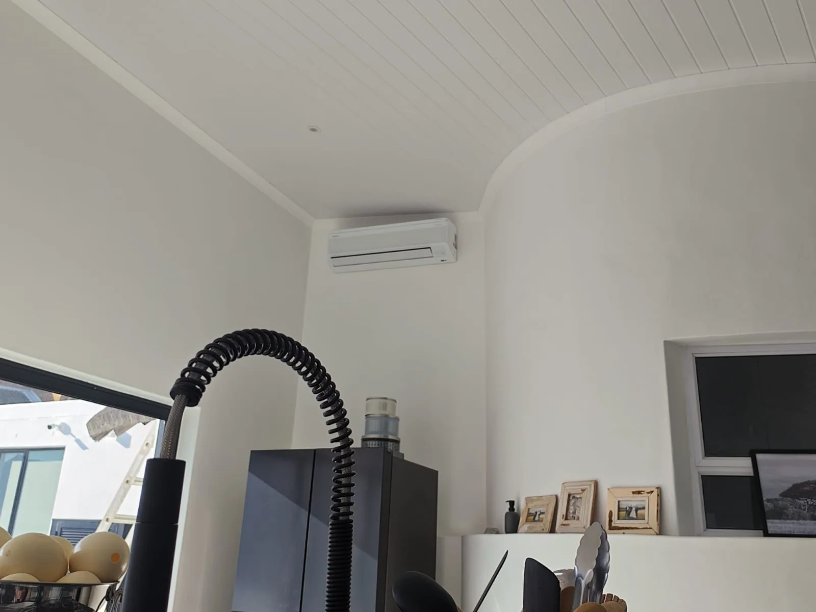 Wall-mounted split air-conditioning unit installed in a bright interior room.