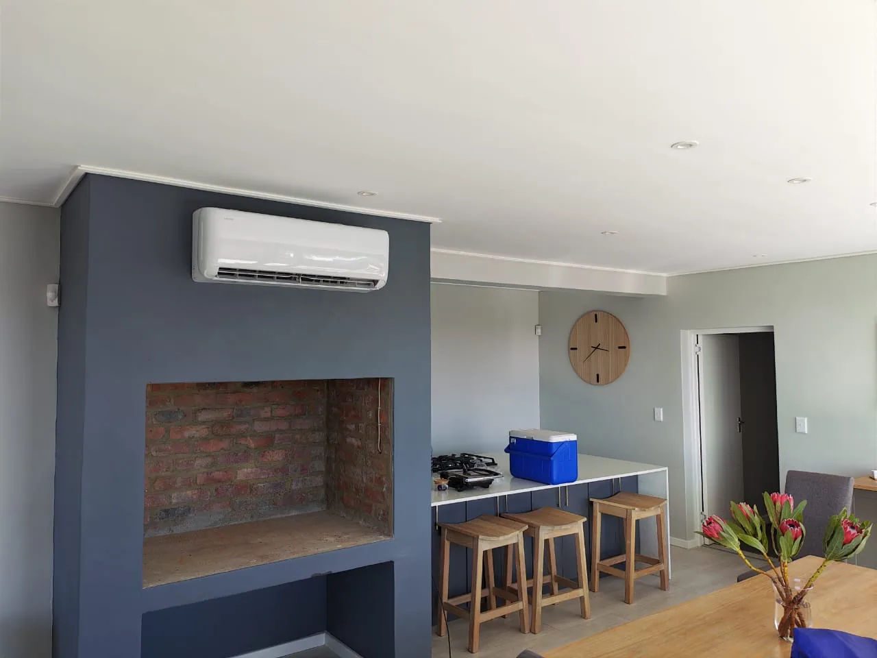Split air-conditioning unit serving an open-plan living and kitchen area.