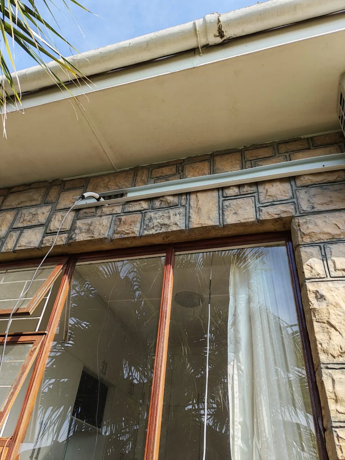 Exterior wall prepared with enclosed trunking for air-conditioning pipework.